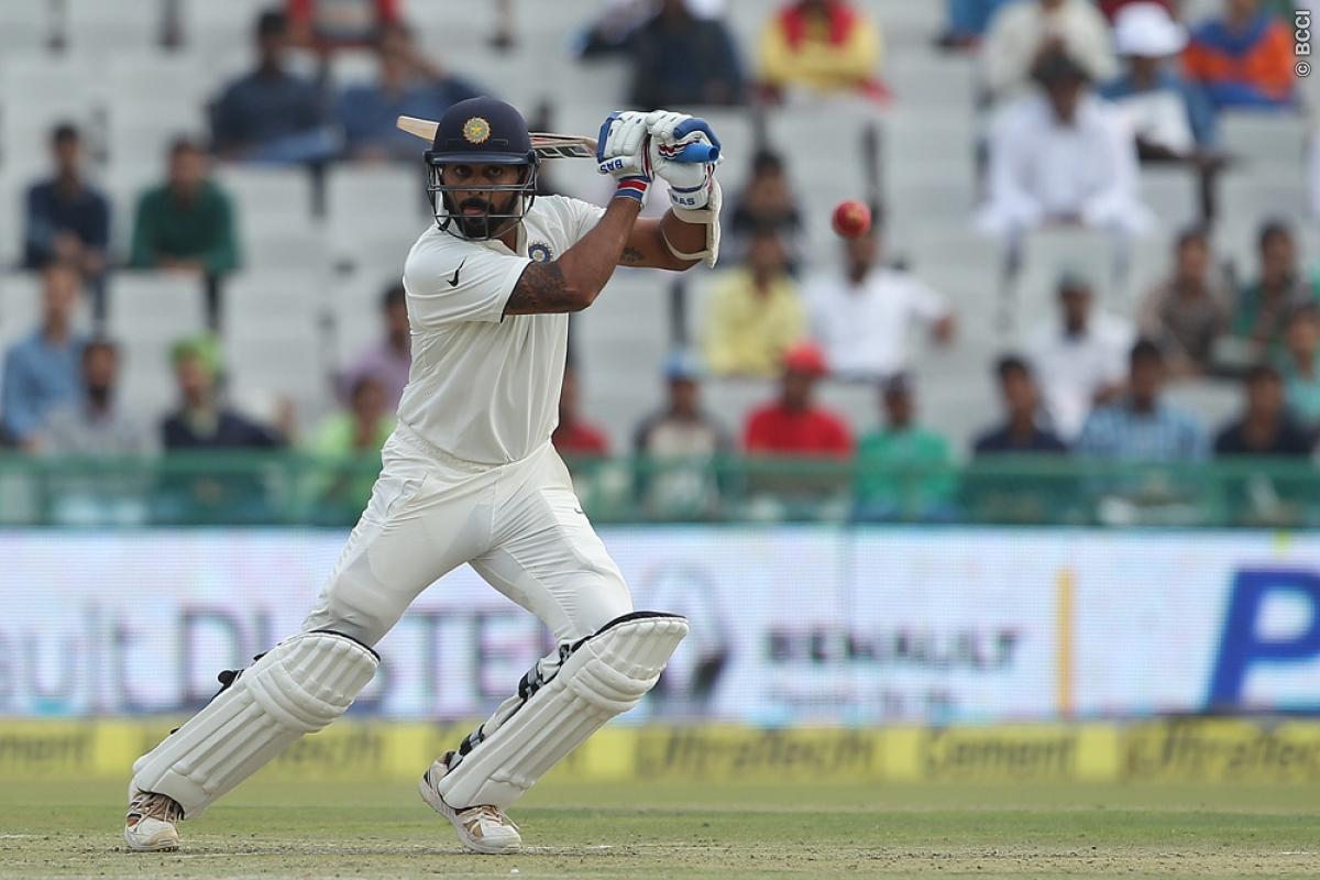 Vijay lifts India to fighting total on a turning Mohali pitch