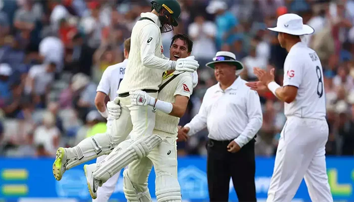 Pat Cummins and Nathan Lyon celebrate after winning the match for the Australian team.