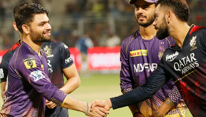 Rinku Singh shaking hands with Virat Kohli.