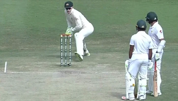 Tim Paine making a run out attempt against Azhar Ali.