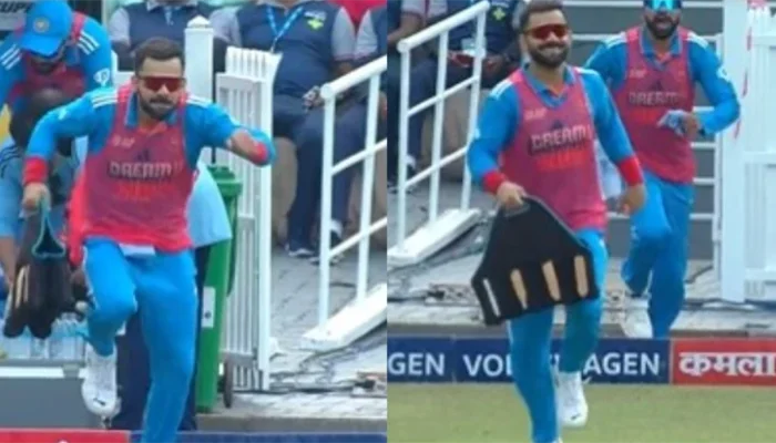 Virat Kohli carrying drinks in a funny manner for the Indian players.